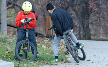 boys on bikes with mobile